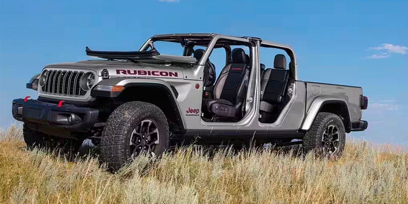 An image of a Jeep Gladiator with its doors removed, sitting in a golden grass field. 