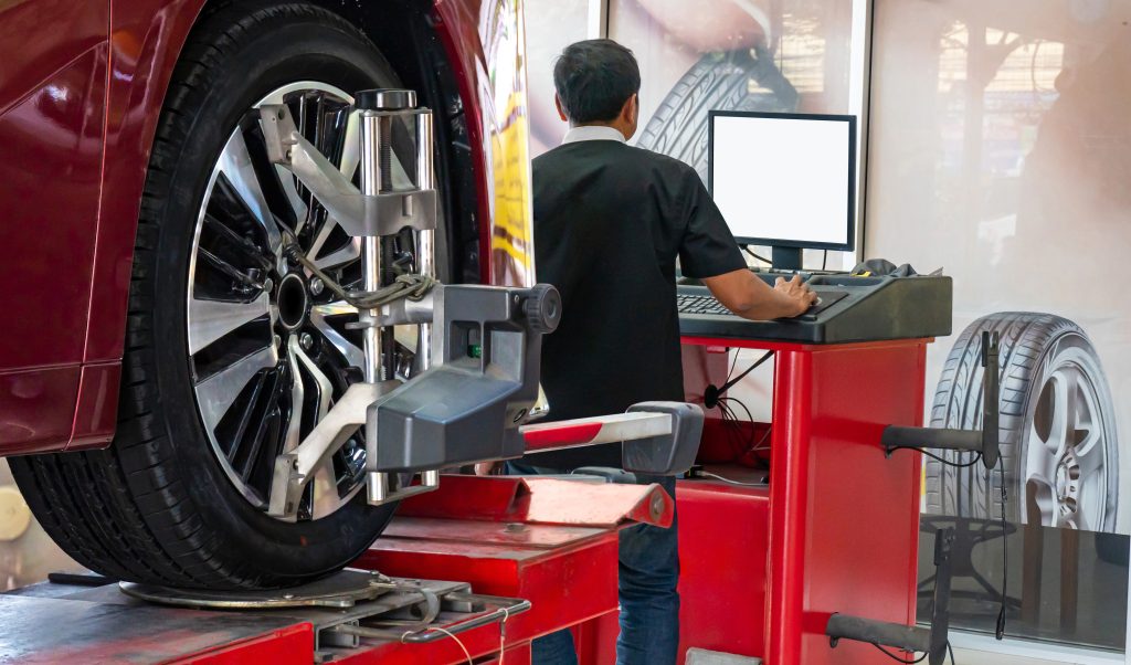 A technician performing a tire alignmnet